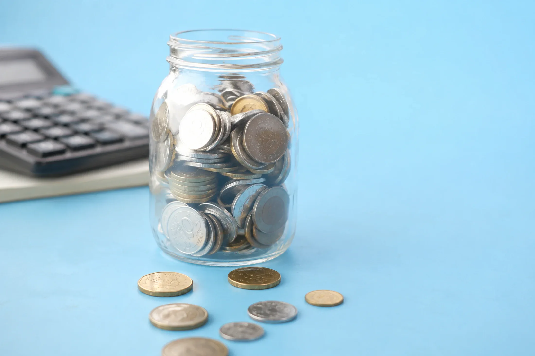 Household cash planning workspace with a calculator, charts, and budget materials